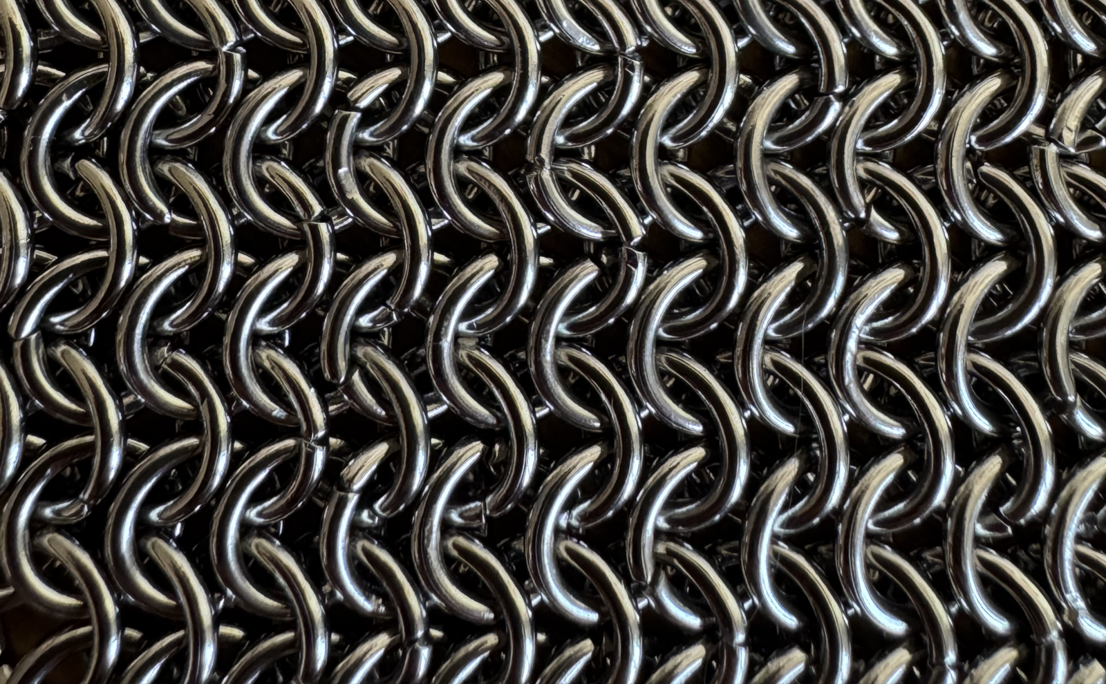 Modern chainmail jewelry including necklace, earrings, bracelet, and crown