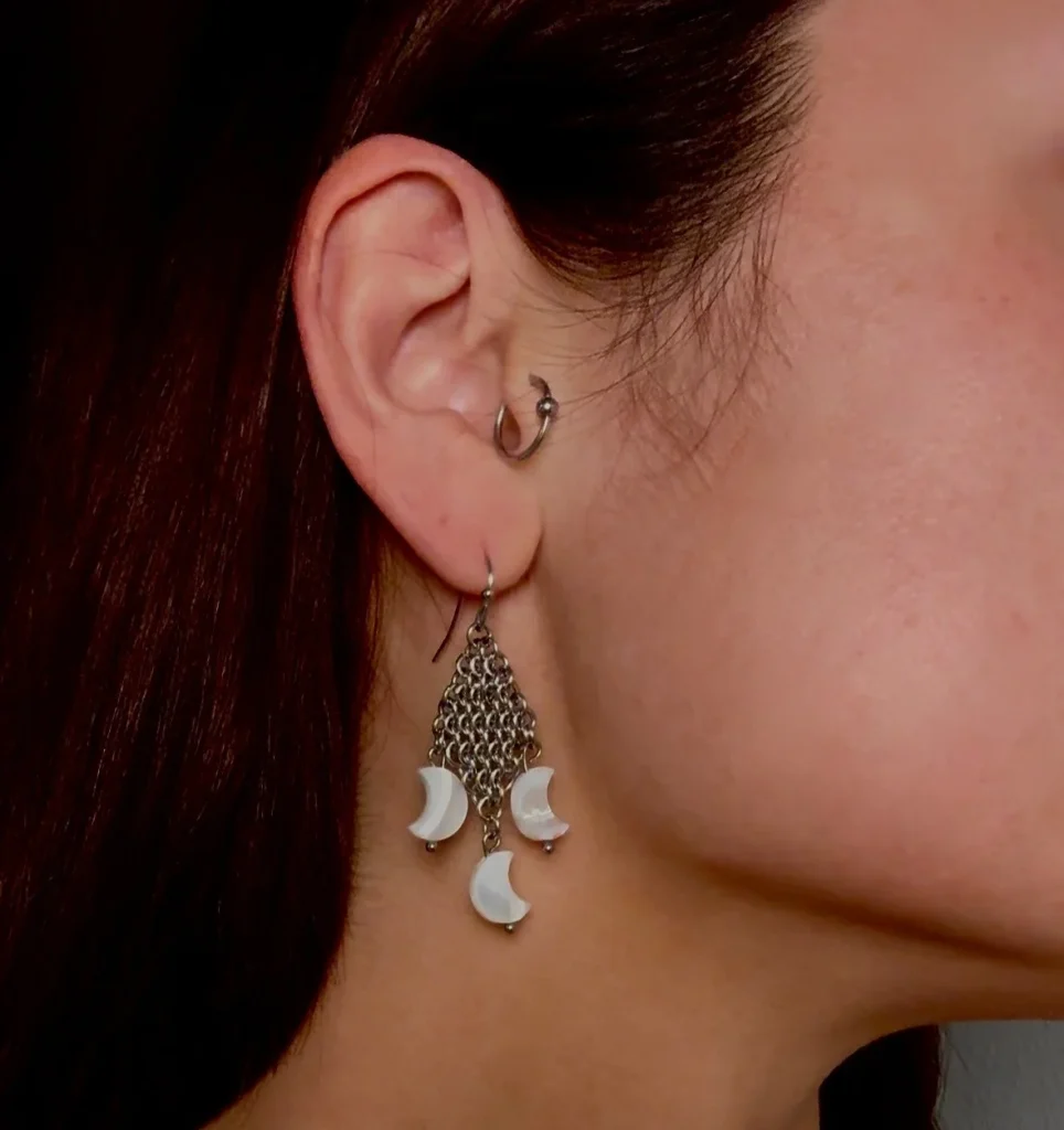 Detail of Crescent fantasy chainmail earrings showing curved, moon-inspired design