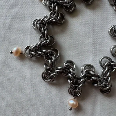 Detail of Lana pearl chainmail bracelet showing pearl and stainless steel ring pattern