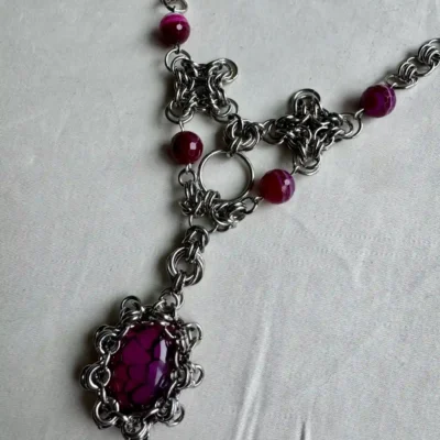 Custom chainmail statement necklace featuring a purple gemstone centerpiece