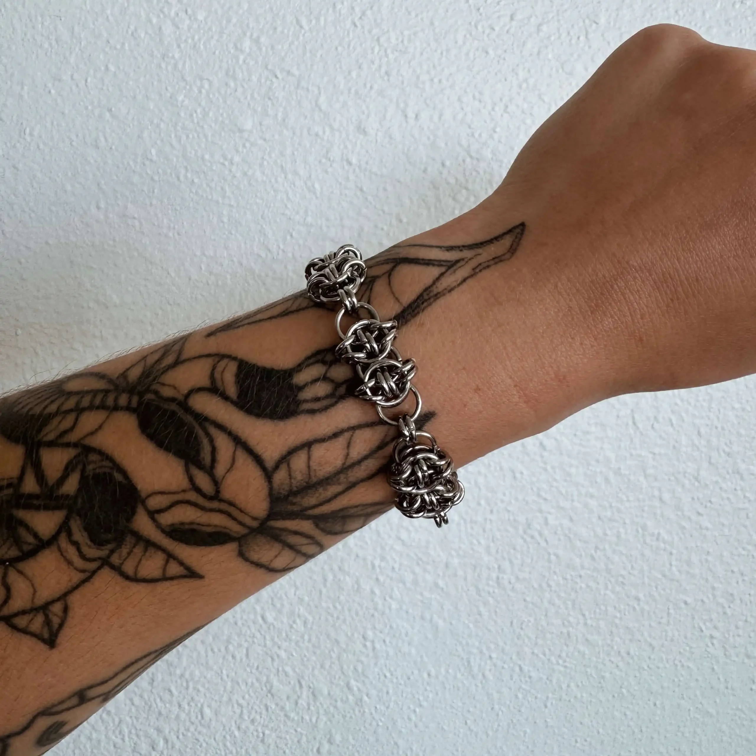 Inez woven chainmail bracelet worn on the wrist showing its detailed ring pattern