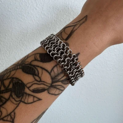 Ingrid wide chainmail bracelet worn on the wrist with layered stainless steel weave