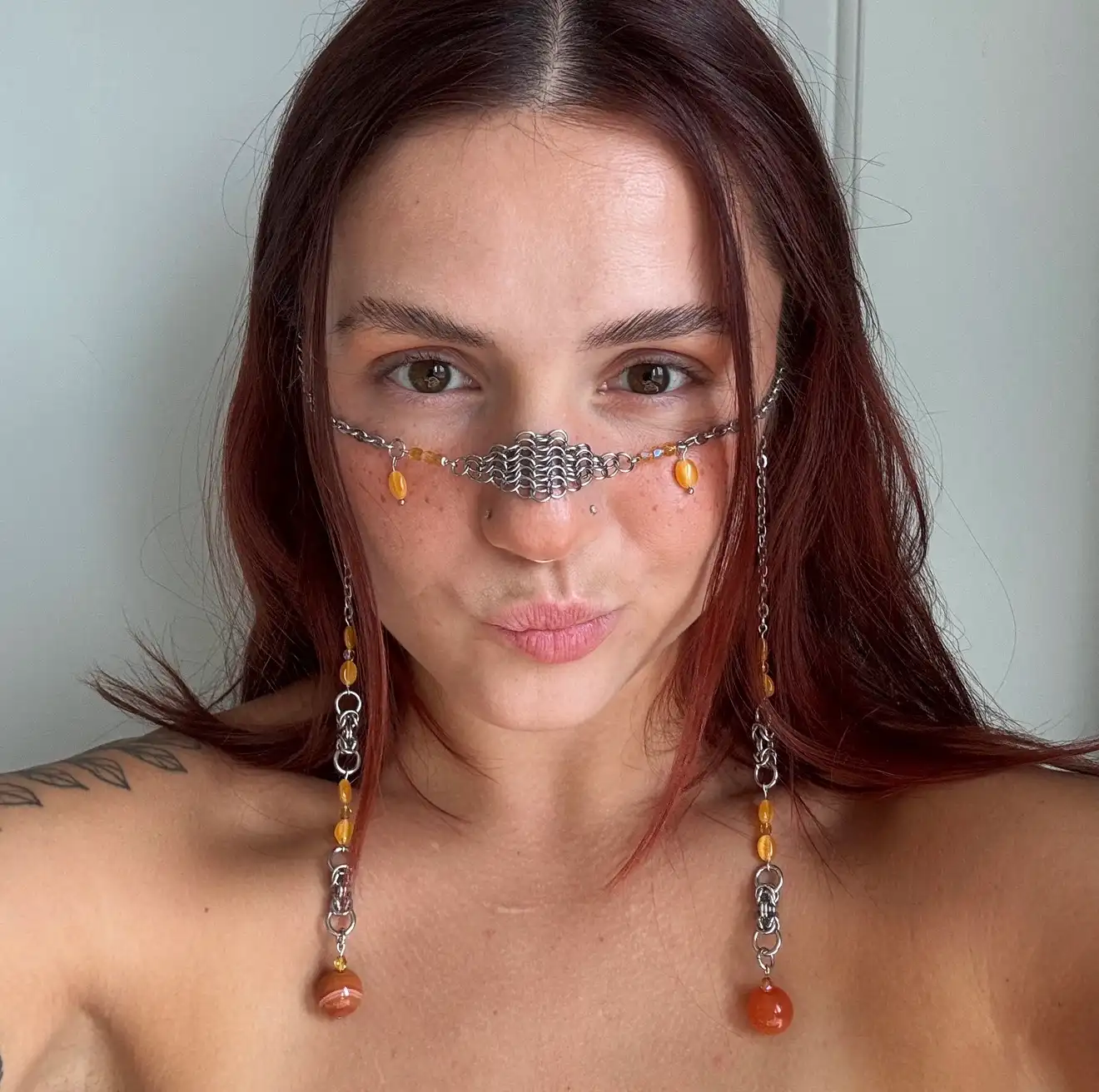 Silver chainmail face chain with orange gemstone beads and dangling side chains