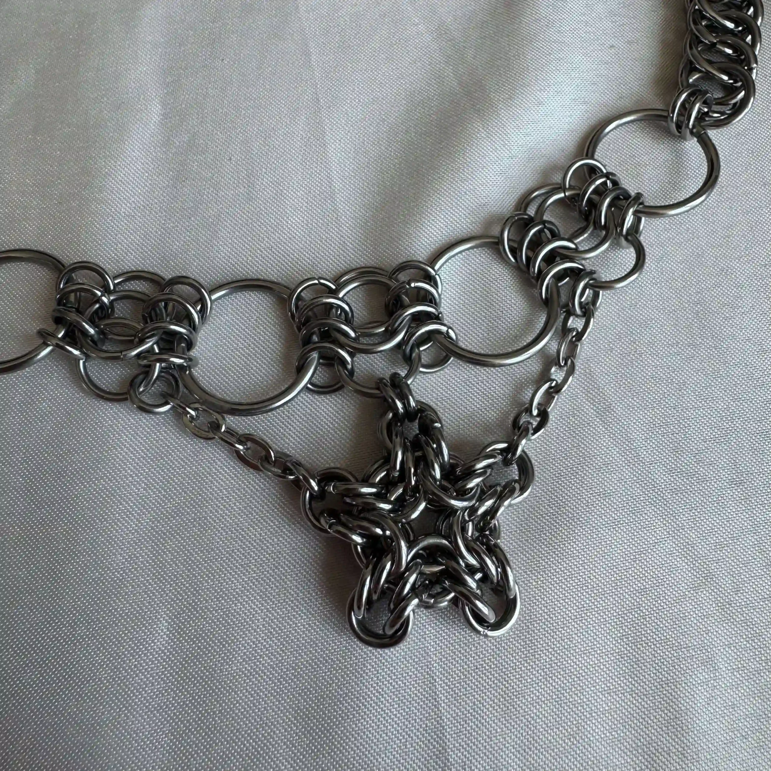 Romy star chainmail necklace detail with woven stainless steel star centerpiece