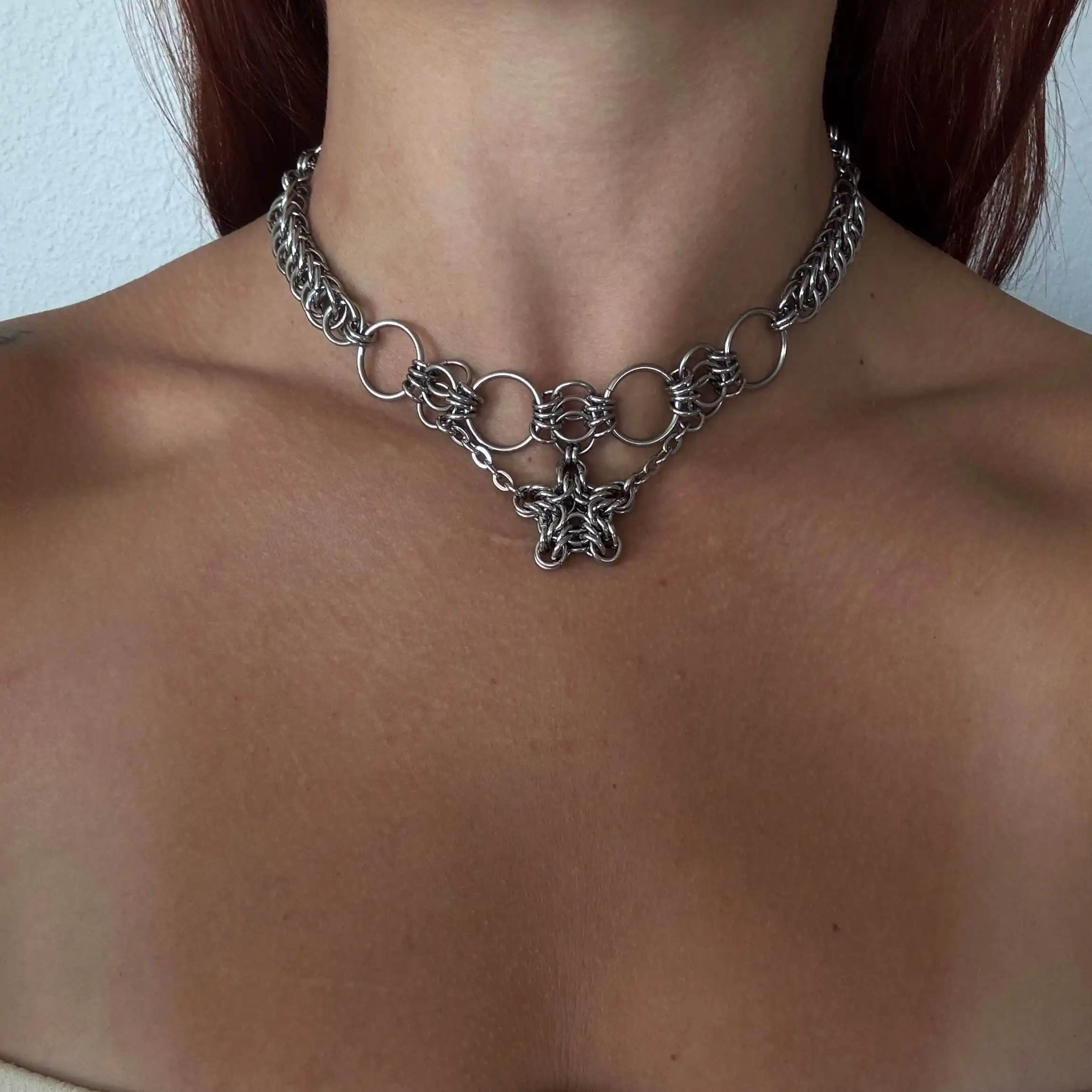 Romy star chainmail necklace worn close to the neck with woven star centerpiece
