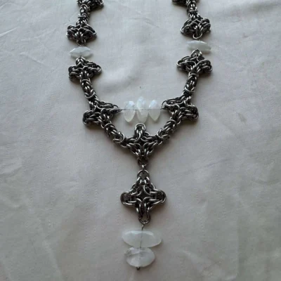 Seraphine White Gemstone Chainmail Necklace Detail Seraphine white gemstone chainmail necklace detail with translucent stones and woven ringwork