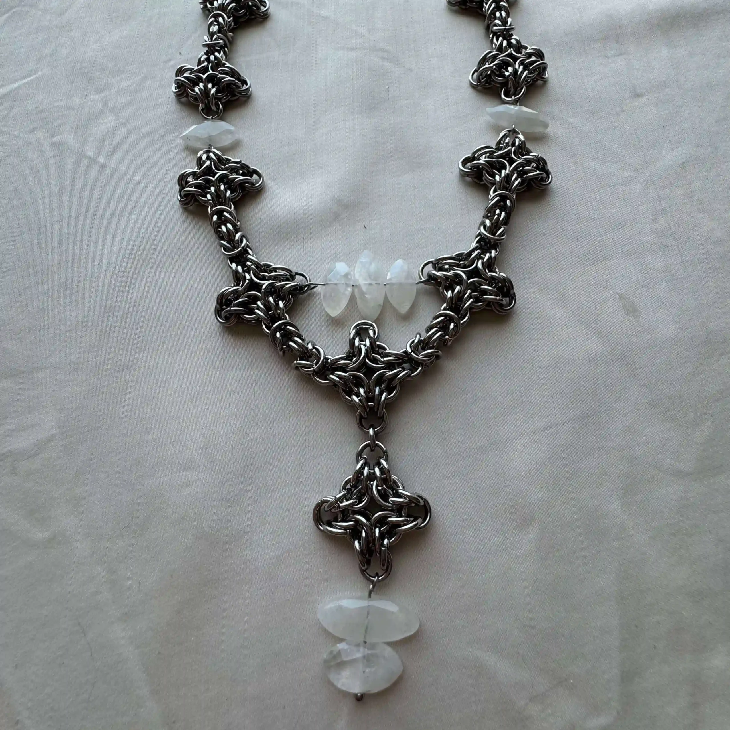 Seraphine white gemstone chainmail necklace detail with translucent stones and woven ringwork