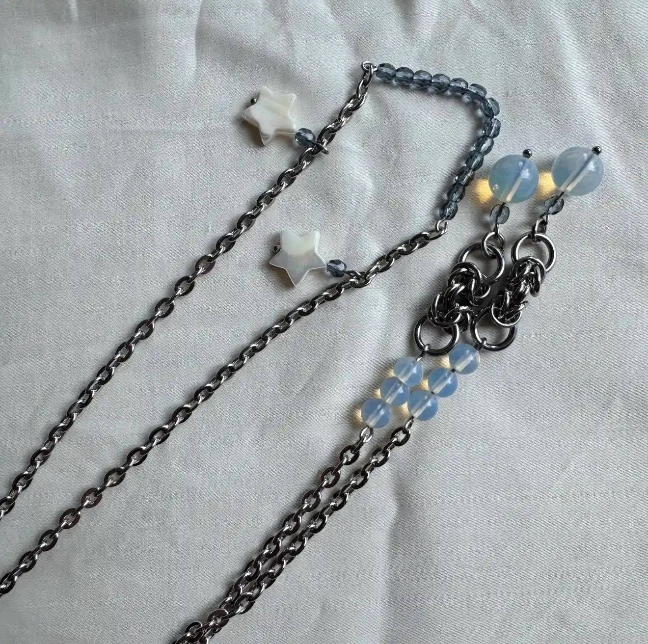 Stainless steel face chain jewelry with white star charms and blue gemstone beads